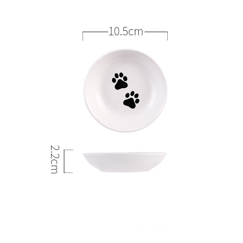White ceramic bowl with black paw prints and measurements on a white background
