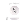 White ceramic bowl with black paw prints and measurements on a white background