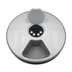 Digital kitchen scale with a clear lid on a white background